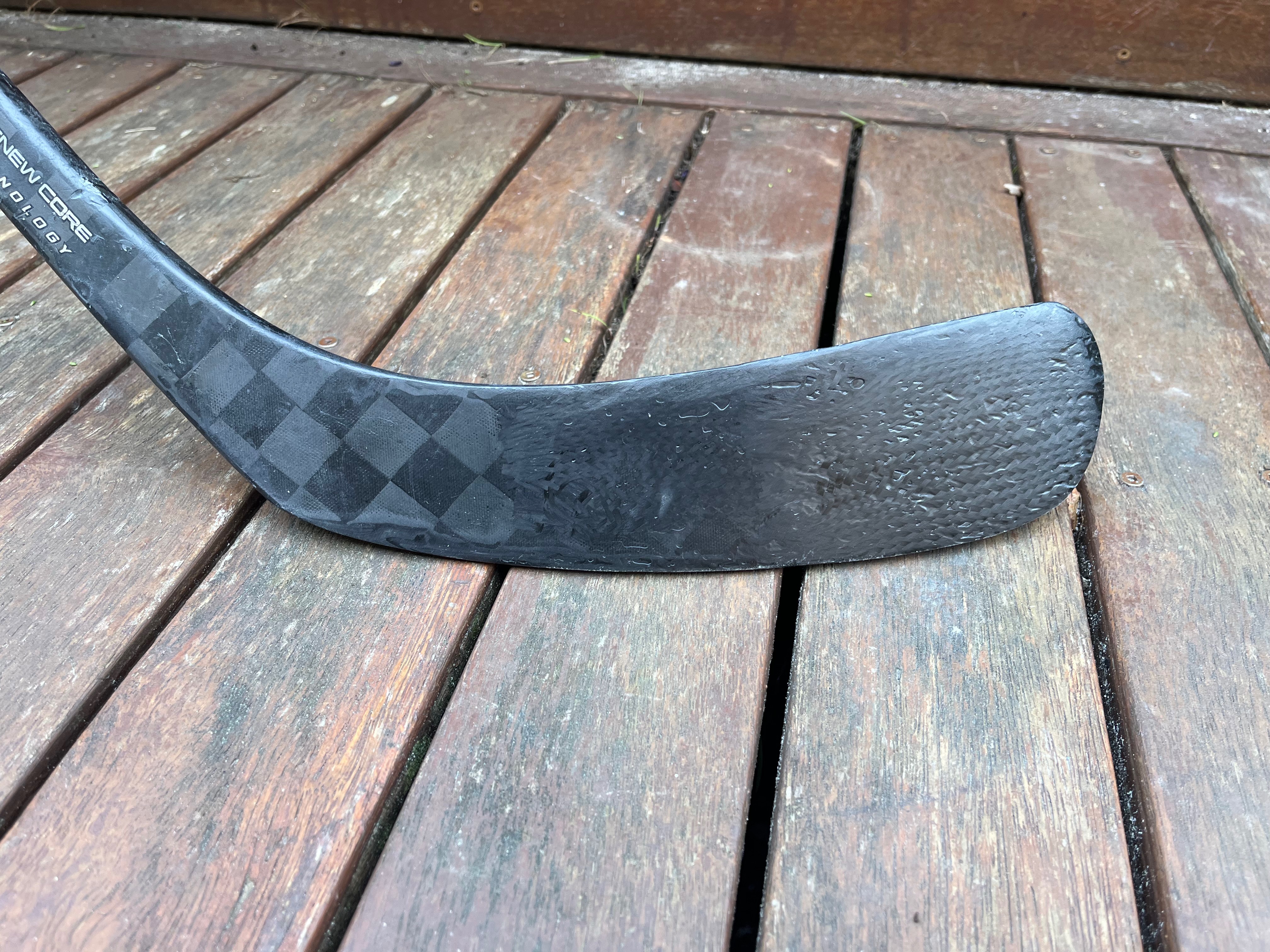 Rebuilt carbon blade face lying on a timber deck