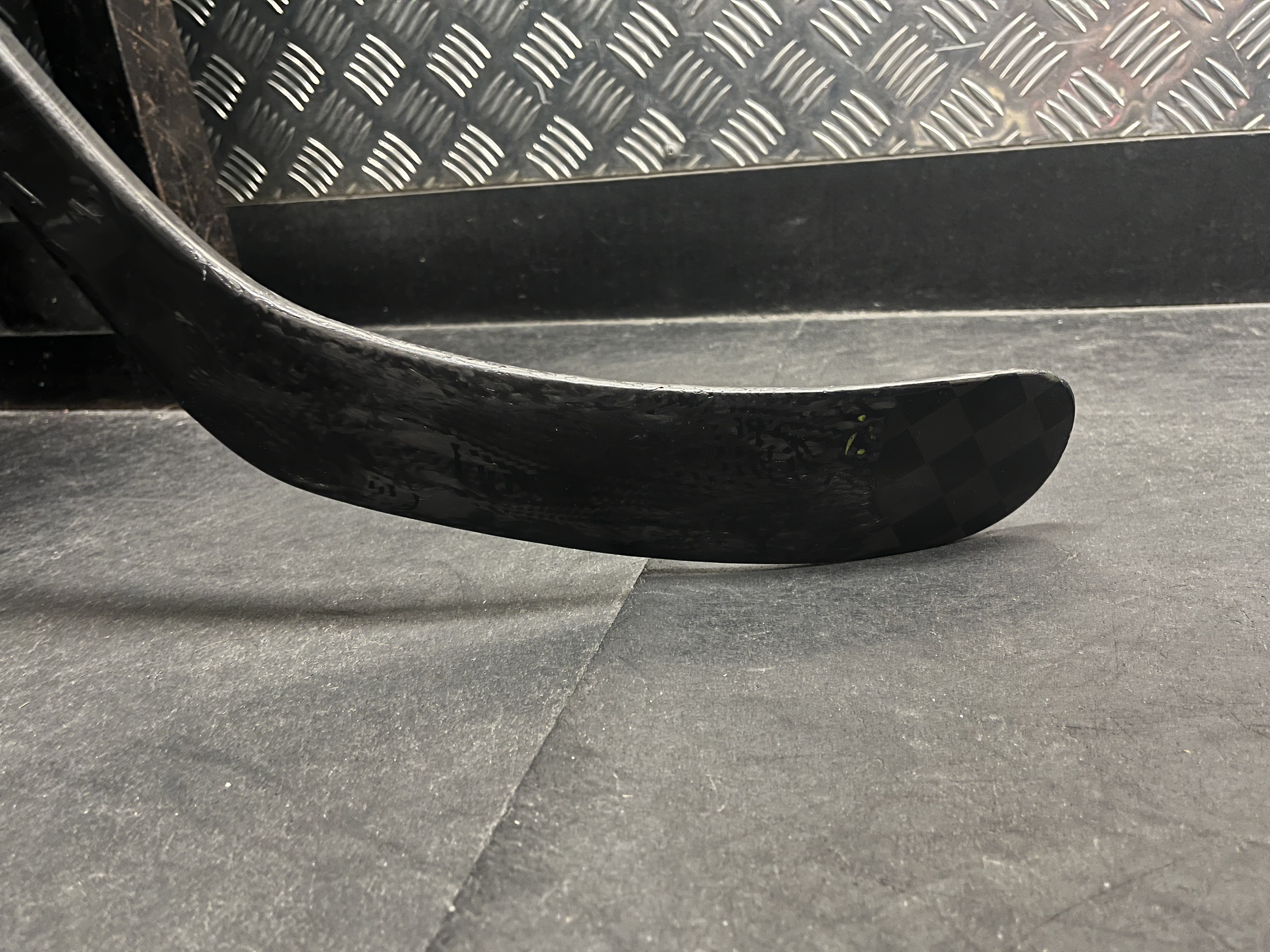 Solid, rebuilt blade resting on the rink floor