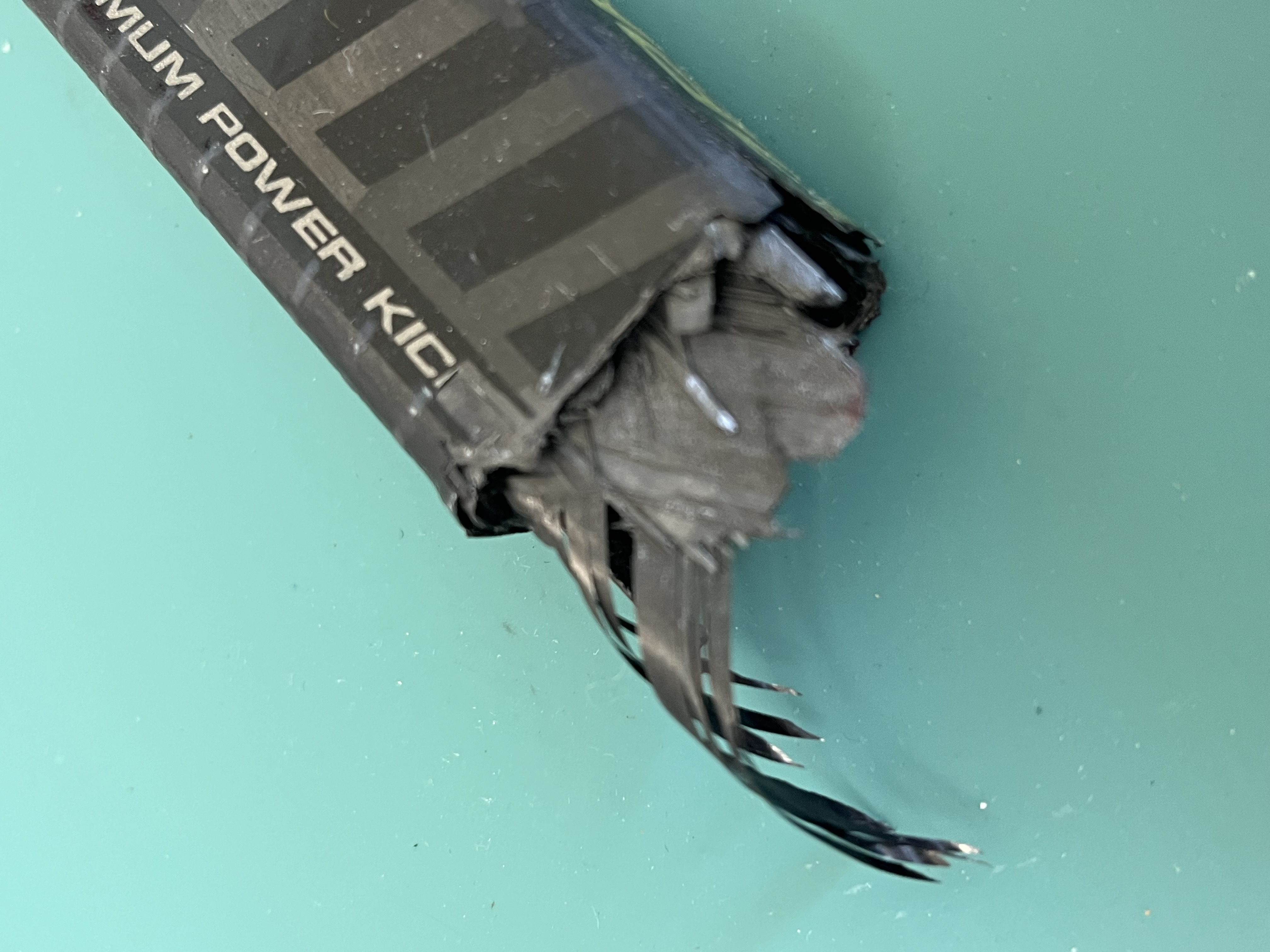 Torn carbon layers and exposed core inside a broken shaft